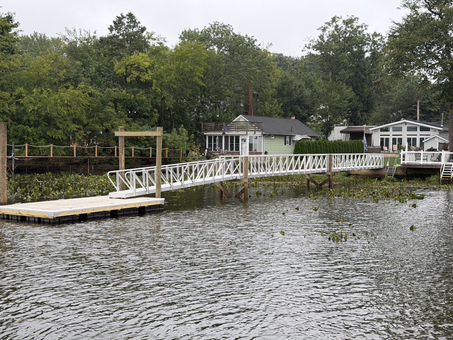 Aluminum gangway and floating dock installed at a residential waterfront